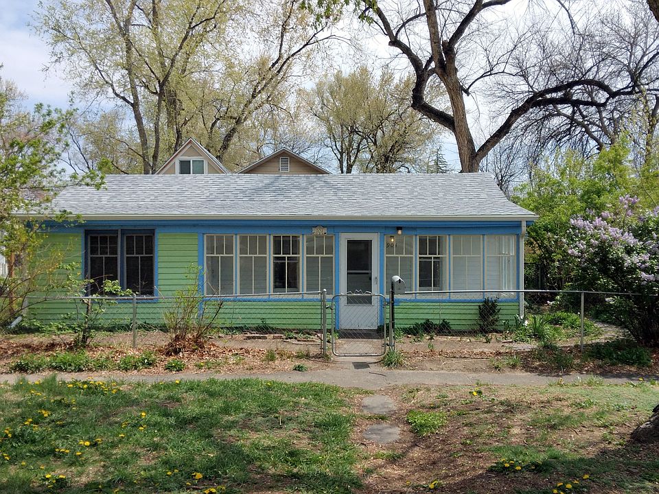 The fenced yard wraps around the front and sides of the house.