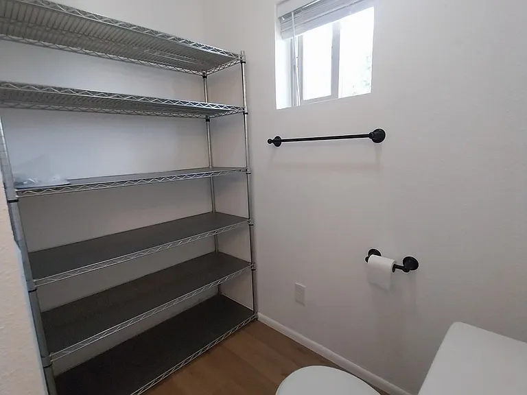 Large shelving unit in hall bath