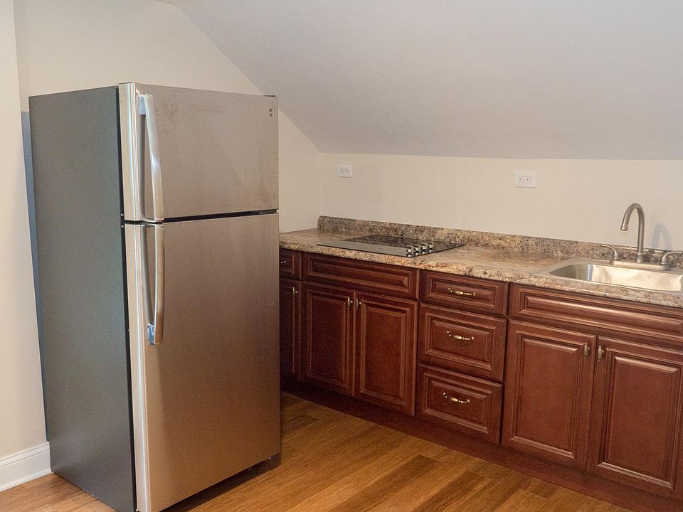 New kitchen counter, sink, cabinets and refrigerator. Stove top only, does not include an oven for baking.
