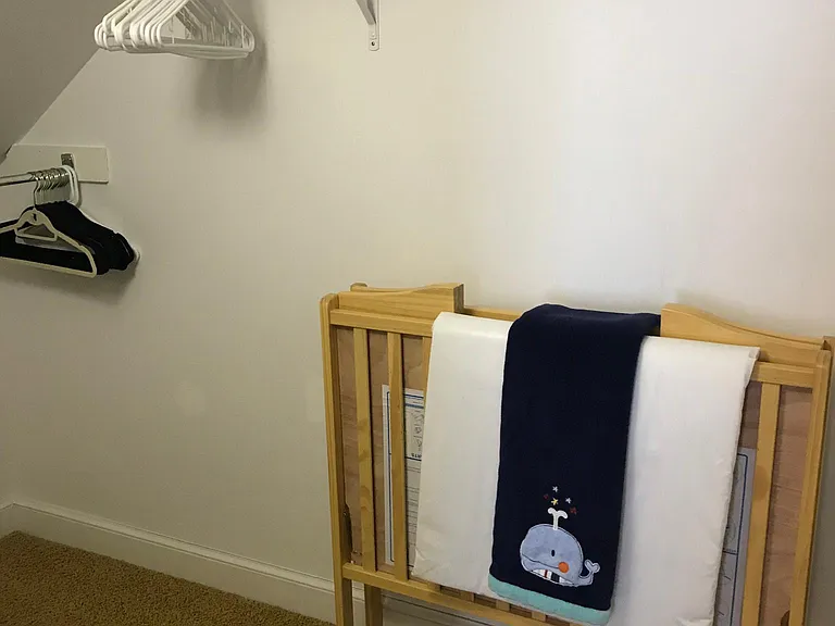 A fold-up and out portable crib located in the large, walk-in closet upstairs