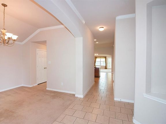 As you enter the home you are welcomed with lovely tile flooring and a large formal dining room to the left.