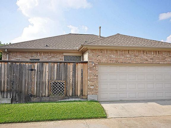 Back view of the 2 car garage and street behind the house.