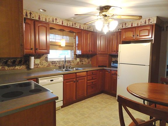 Updated eat-in kitchen with Cherry cabinetry measures 12x10.
