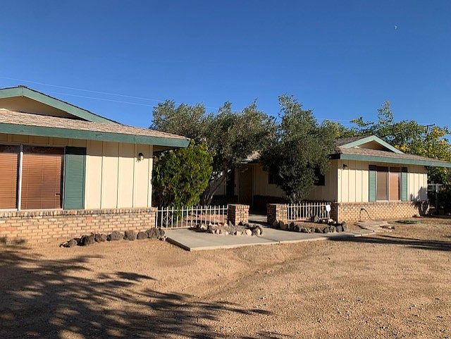 Yard has circular drive, mature landscaping and fenced rear yard for a pet or play.