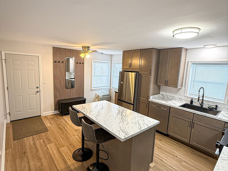 Fully renovated kitchen with island and space for an additional table
