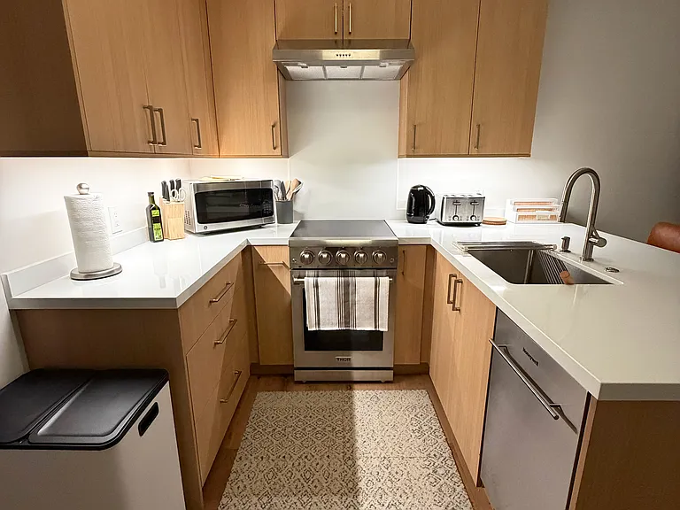 Fully Appointed Kitchen Showing all new Range, Dishwasher, Microwave, Kettle, Toaster, Trash/Recycling/Compost Bins (Coffee Maker not shown)