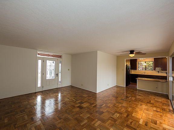 Living room looking back at the front door and into the kitc
