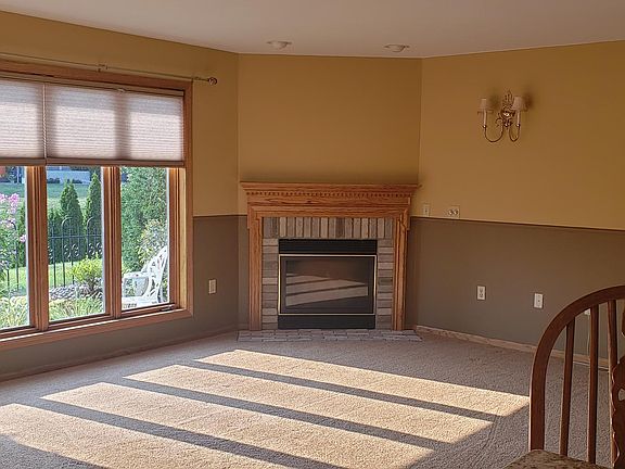Natural gas fireplace in living room. Large windows overlooking private flower garden. Blinds included.