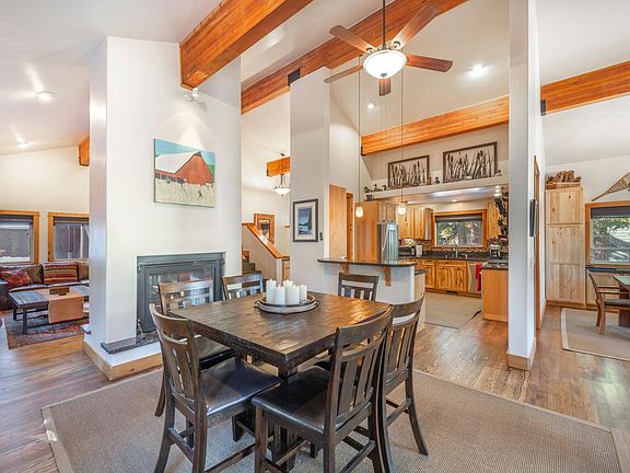 Fun counter-height pub table adjacent to kitchen, living room, dining room and deck