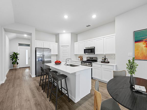 Kitchen in the Cedar home plan by Trophy Signature Homes - REPRESENTATIVE PHOTO
