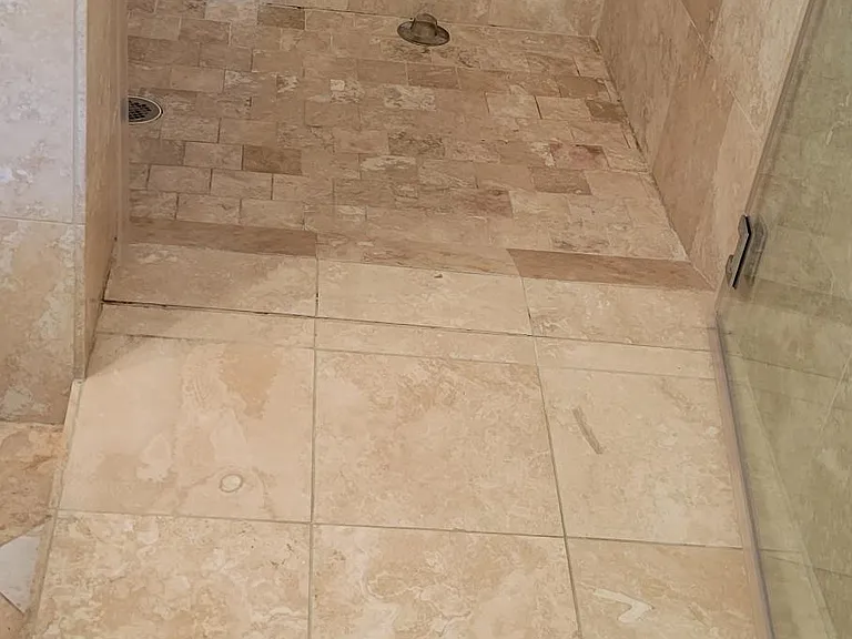 ADA-compliant shower with ramp and grab bars
