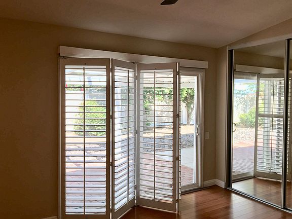 Plantation shutters in bedroom. New double-pane sliding patio doors lead directly to patio. Overhead fan and separate dimmable lights over each side of the bed. All bedrooms have overhead fans. Three overhead fans in the great room. Adjustable attic fan.