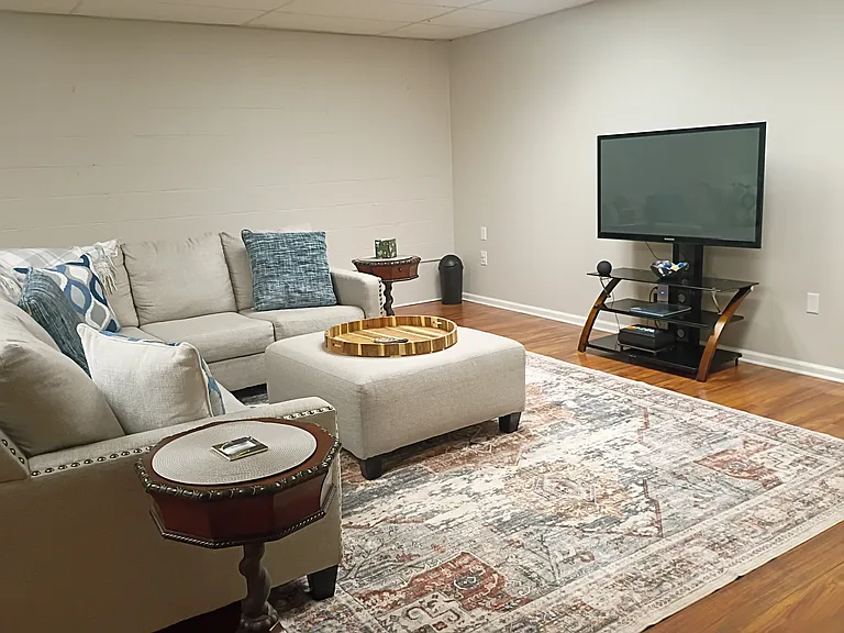 The family room is located in the basement, and includes a Smart TV. Because this level is naturally cooler, a space heater is provided.