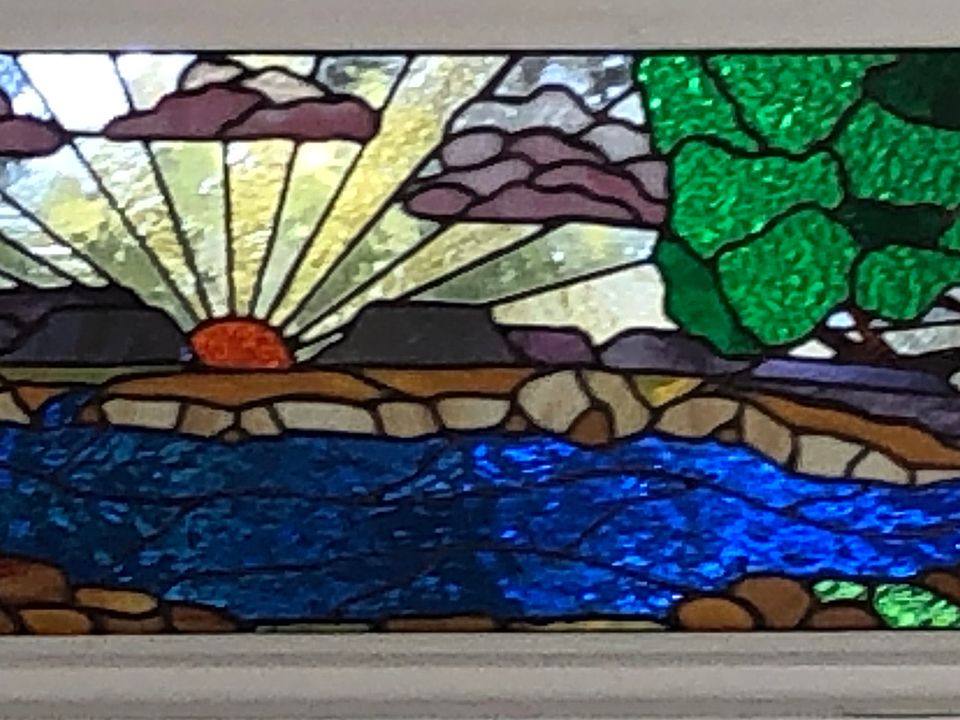 Stained glass transom over front door was created by a neighborhood artist, Randall Soileau