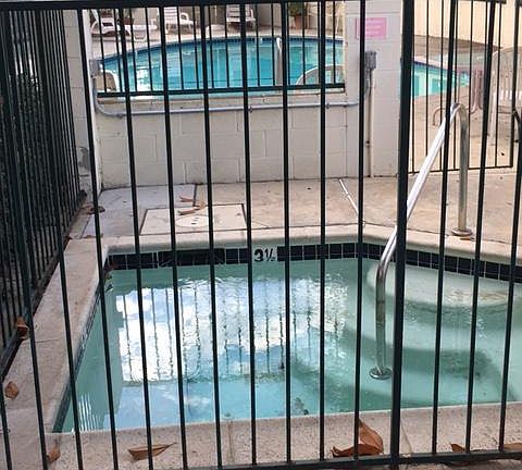 spa in foreground and swimming pool in distance