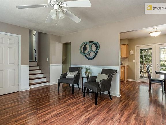 3rd view - Living room looking with coat closet and wood steps lead you to bedrooms and bath.