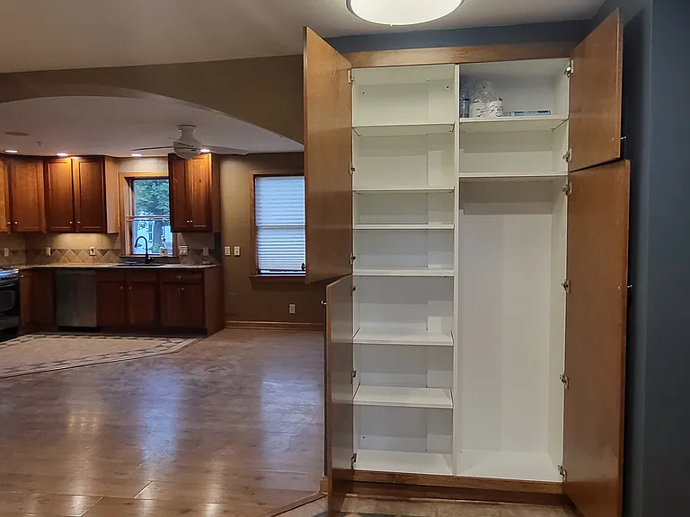 linen / broom closet with adjustable shelves