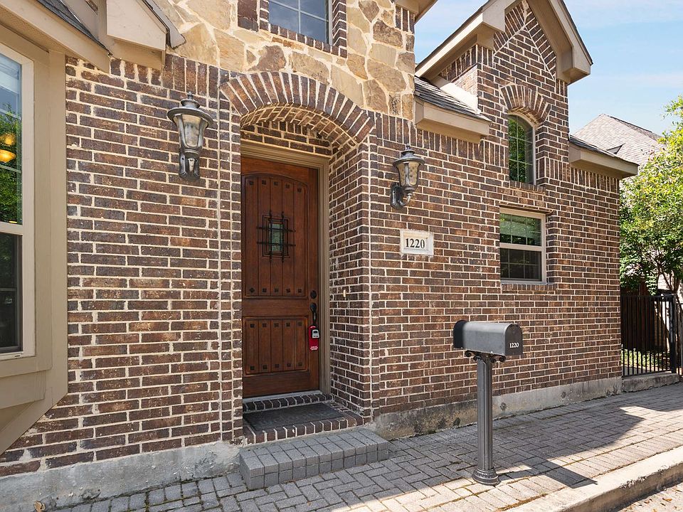 Entrance to property featuring brick siding