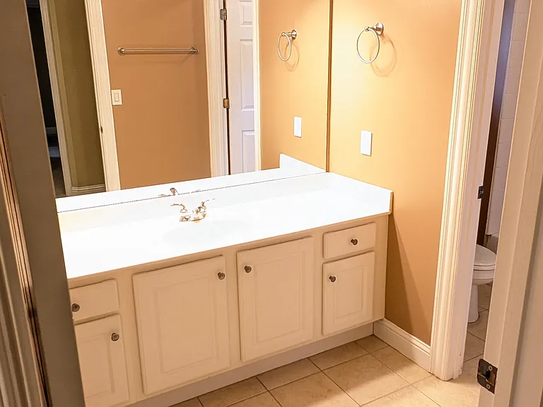 Second floor hall bathroom has large vanity top and two separate rooms. One with the vanity, and one with the toilet and shower/tub.