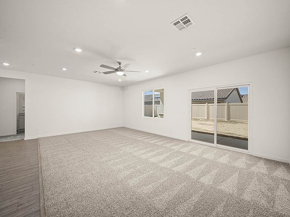 The family room is spacious with a ceiling fan.