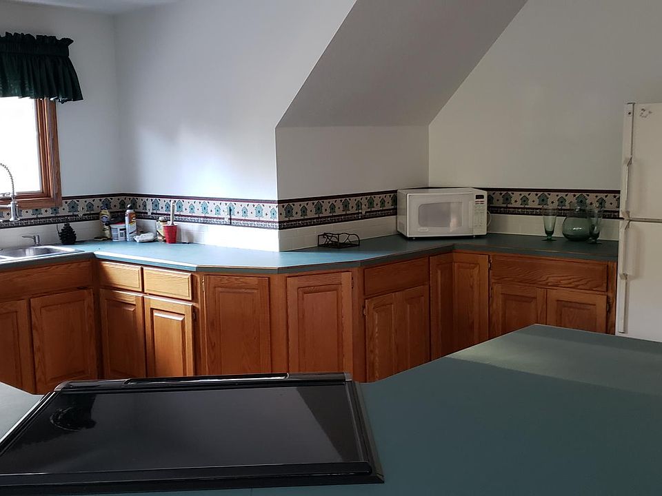New flat top stove and stainless steel sink with new faucet.