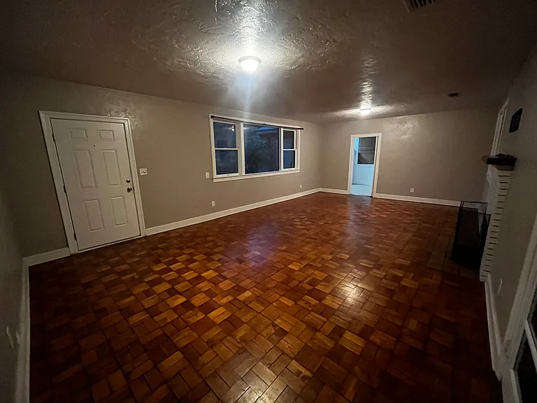 Living room, window to front yard and door to kitchen