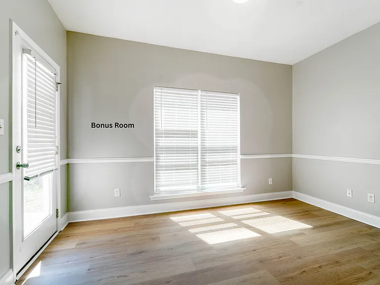 Bright sunroom/home office offering seamless access to the backyard