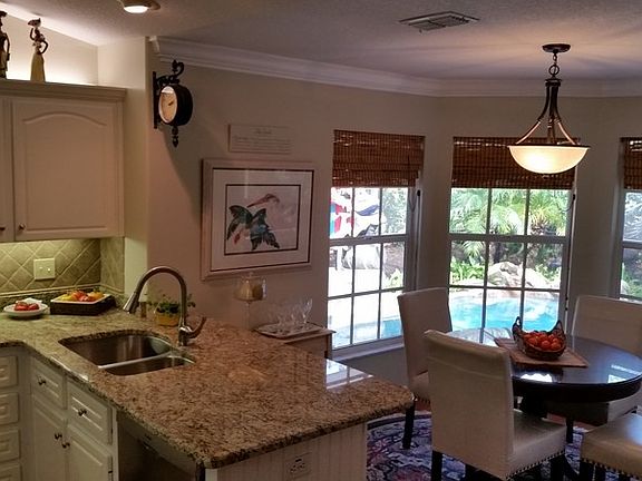 Great view from Kitchen
						:
						Kitchen/ bkft. nook looking out to pool
Granite countertops with s/s sink.