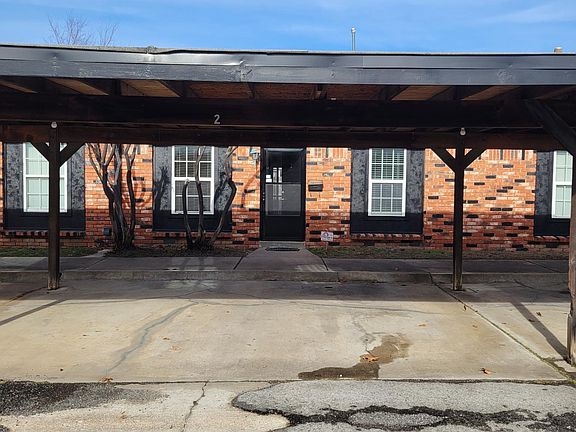 Covered lighted parking for 2 vehicles in front of apartment