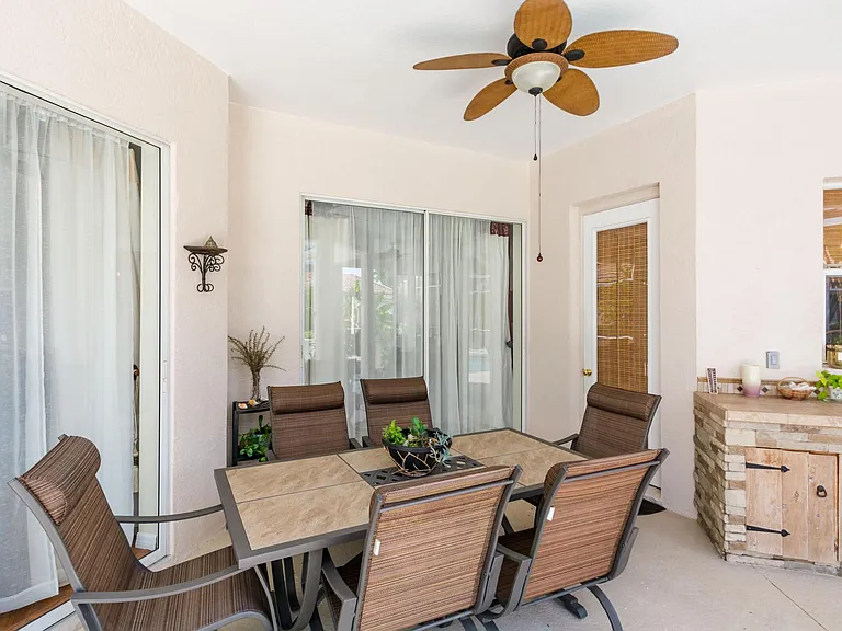 Covered outdoor dinning area overlooking the pool.