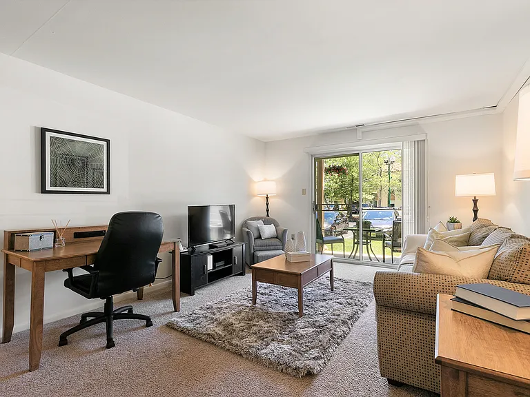 Spacious Living Room with Sliding Glass Doors Leading to Private Patio or Balcony