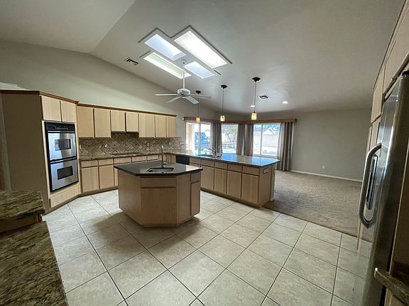 giant size kitchen with loads of storage, double oven, a large island, and dual kitchen sinks