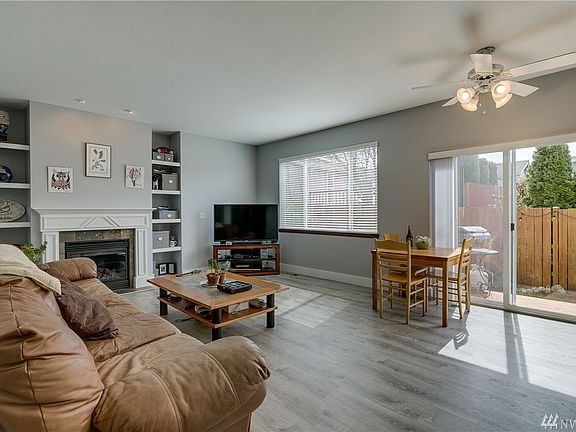 Bright spacious family room with gas fireplace, durable vinyl decorator floor and EZ backyard access.