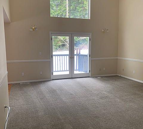Frontroom with vaulted ceilings, French doors & high windows for watching the cedars, deer and birds.