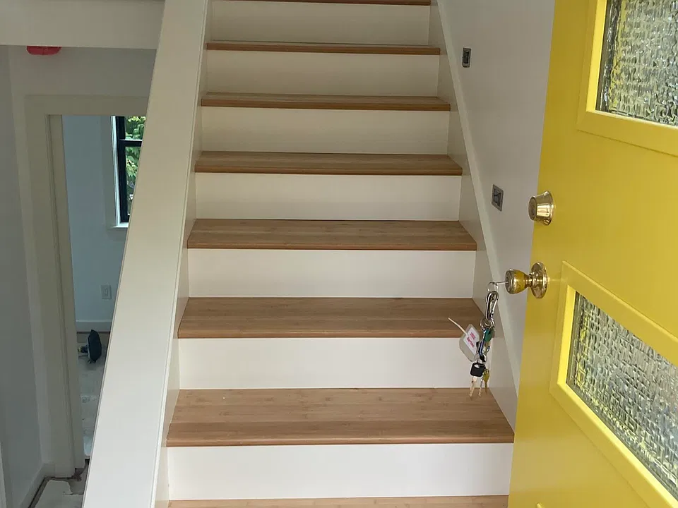 Stairway from front door up to living area and kitchen. 2 Bedrooms & bath are below.