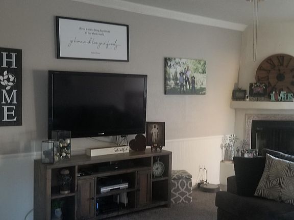 Large living room with fireplace, vaulted ceilings and large window