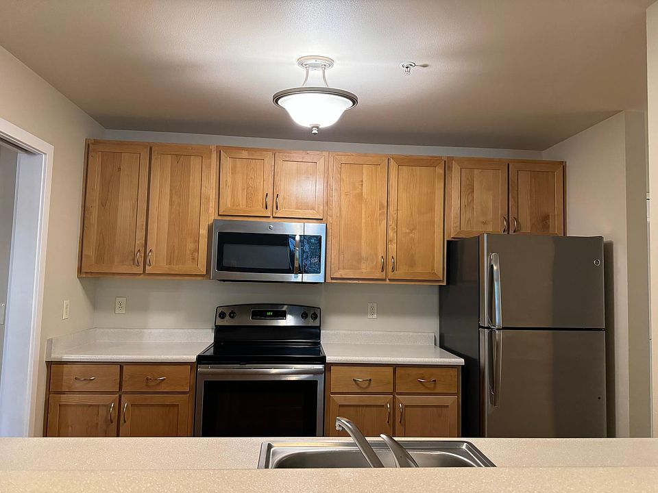 Kitchen view with stainless appliances and natural wood