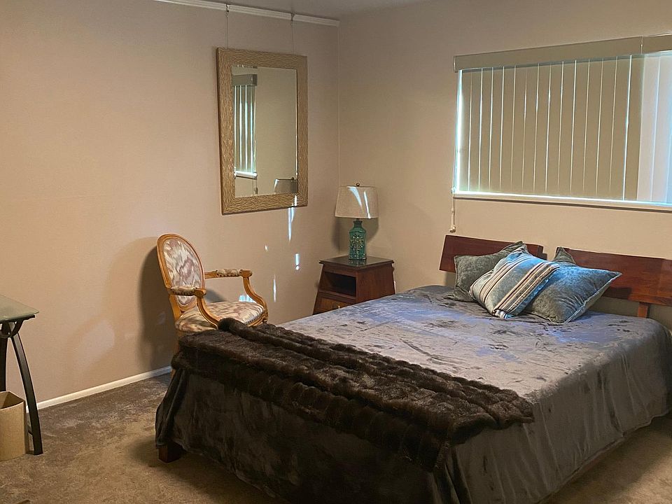 Furnished bedroom with linens.