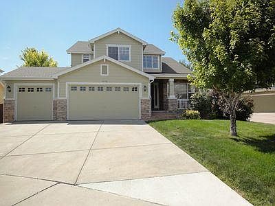 Beautiful two story home with three car garage, front porch and backyard with patio.