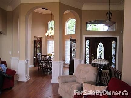 Foyer : fourteen foot ceilings, arched columns, bay window, custom crown moldings