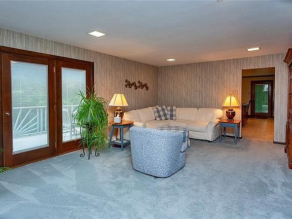 Charming french doors from the family room opens up to a deck overlooking the beautiful grounds. Harwood floors are under the pl