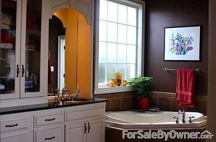 Master Bath : Garden tub, double vanity, glass front cabinetry, lots of natural light.