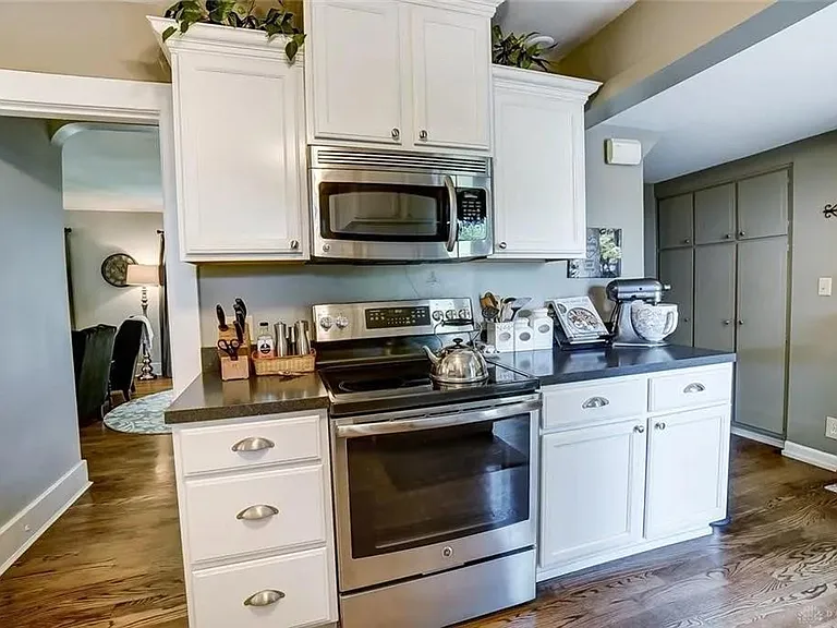 Kitchen showing smooth top range and over the counter microwave oven