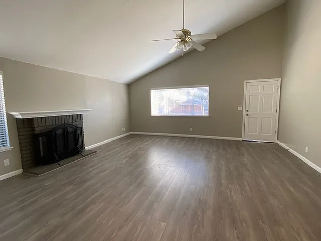 Large living room with vaulted ceilings and wood burning fireplace