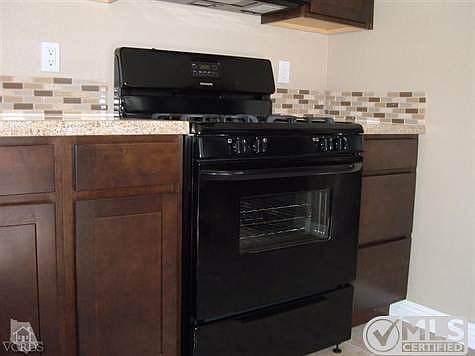 Granite Counters w complimentary Glass tile Backsplash.