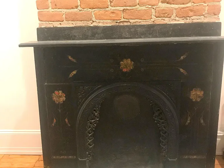 There is an original 1890's slate fireplace with marble inlay, in the living room (non-functional)