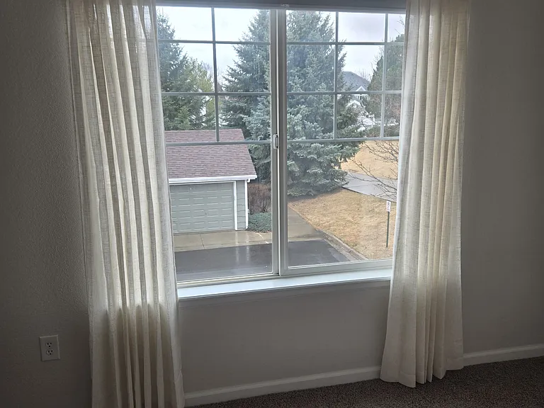 Renters bedroom with window and ceiling fan