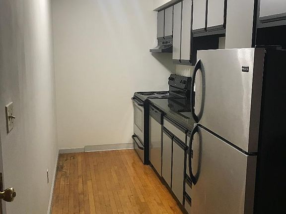 Galley kitchen with ample storage. Granite counter top, full size electric range, dishwasher & fridge/freezer make meal prep a pleasure.