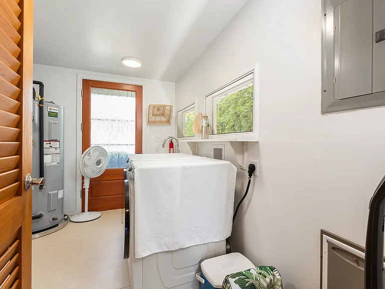 Dedicated laundry area with full-size washer and dryer and exterior access.