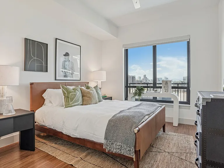 Unwind in this serene, sun-drenched bedroom that blends comfort and contemporary charm.